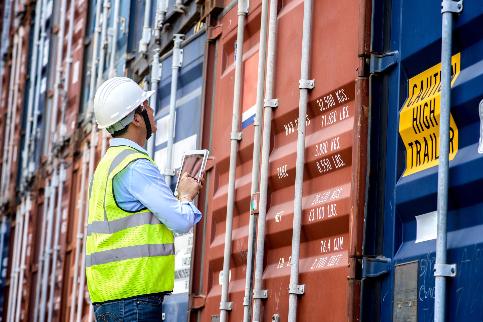 Foreman control loading Containers box from Cargo freight ship for import export.