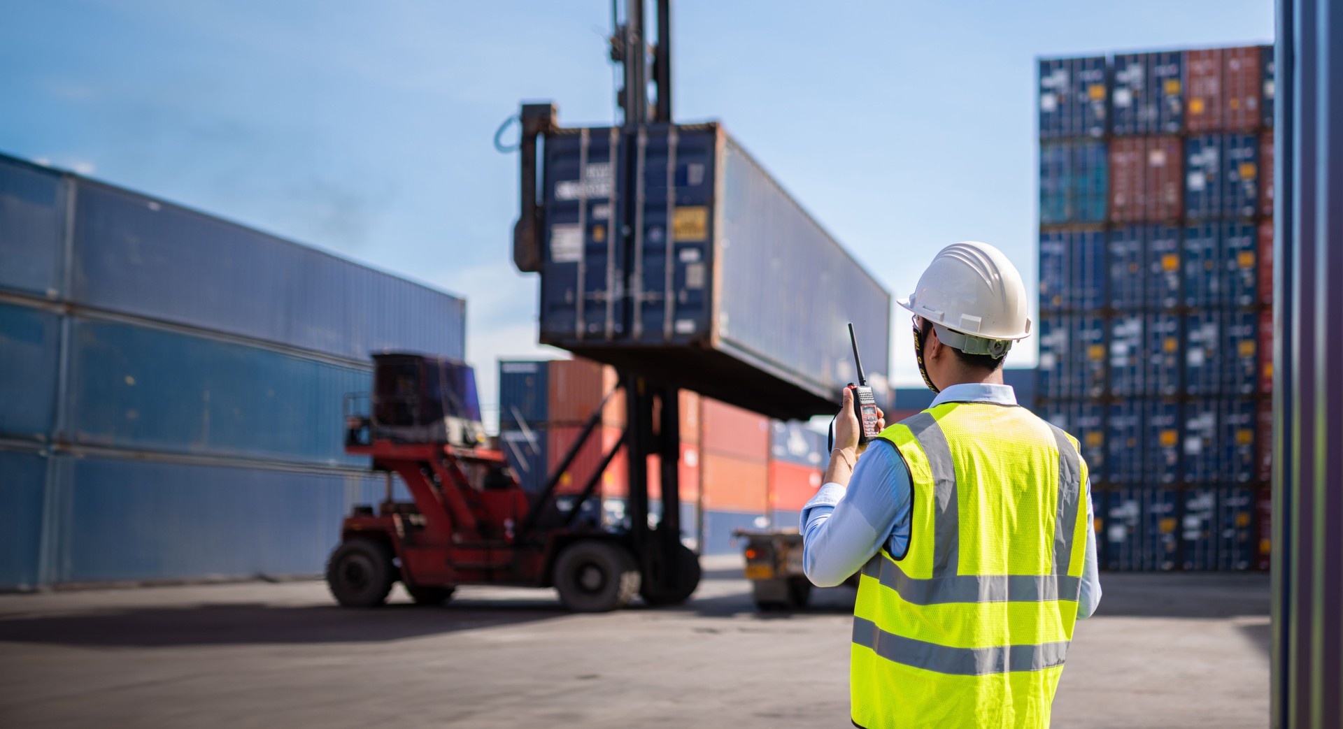 Foreman control loading Containers box from Cargo